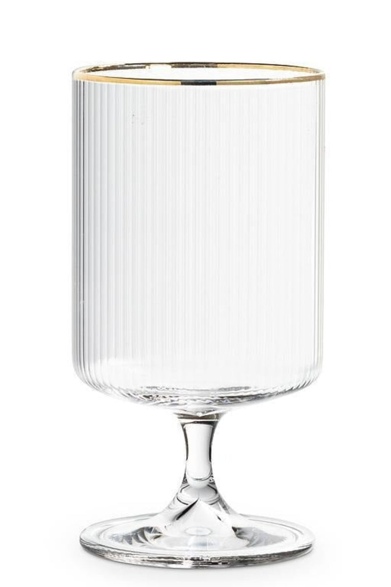Clear ribbed glass with gold rim on a white background