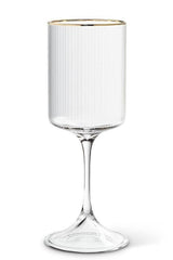 Clear ribbed glass wine glass with gold rim on a white background