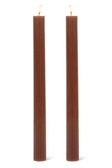 Two brown ribbed candles on a white background