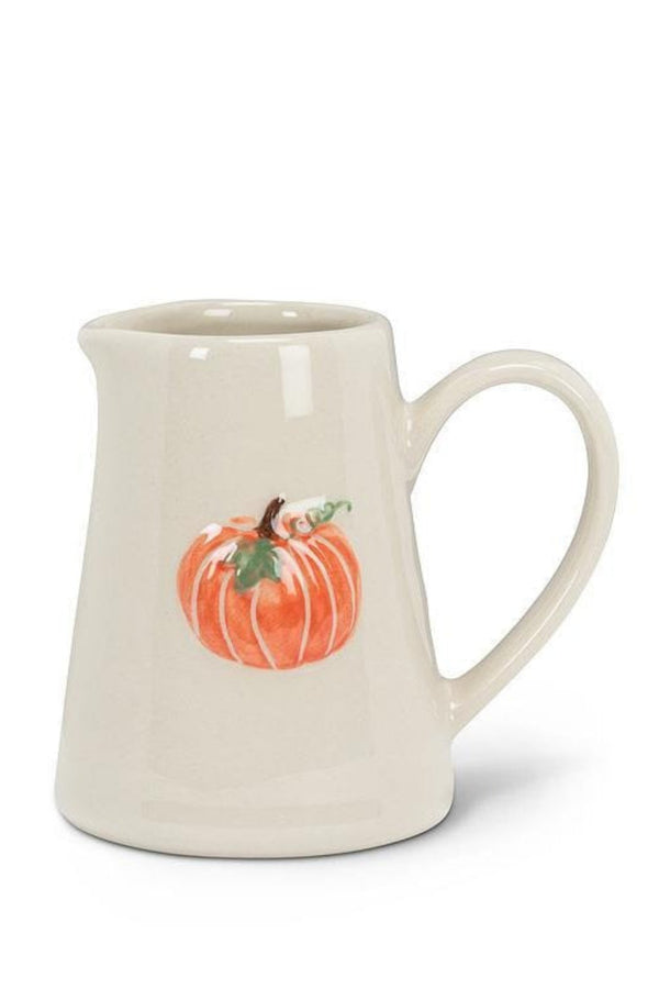White ceramic mug with a pumpkin design on a white background