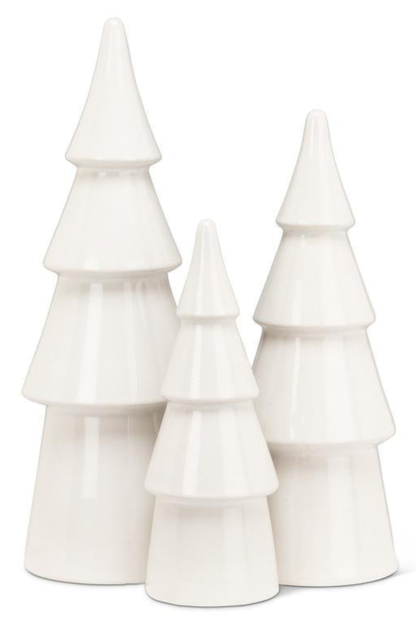 Set of three white ceramic Christmas trees on a white background