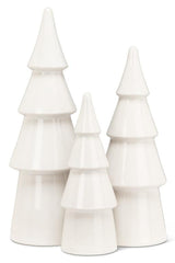 Set of three white ceramic Christmas trees on a white background