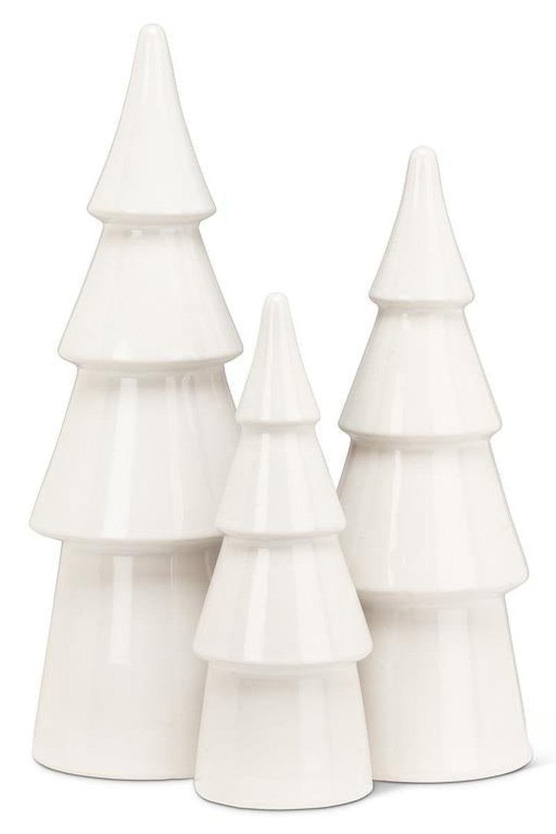 Set of three white ceramic Christmas trees on a white background