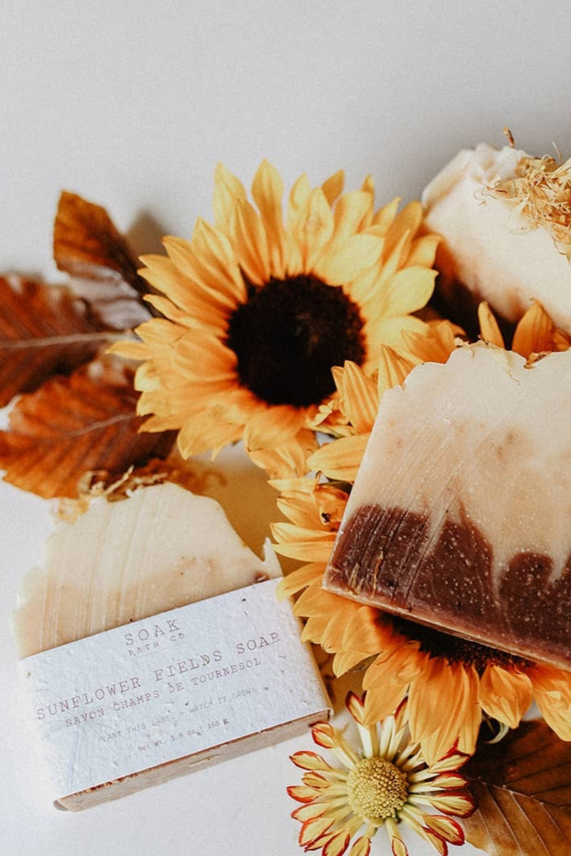 Three bars of soap on sunflowers with a white background