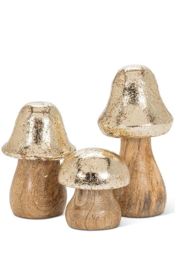 Three decorative mushrooms with metallic gold caps on a white background