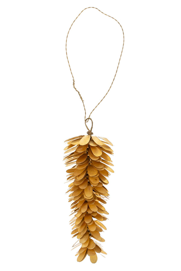 Brass pinecone ornament hanging against a white background