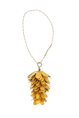 Gold pine cone ornament on a white background