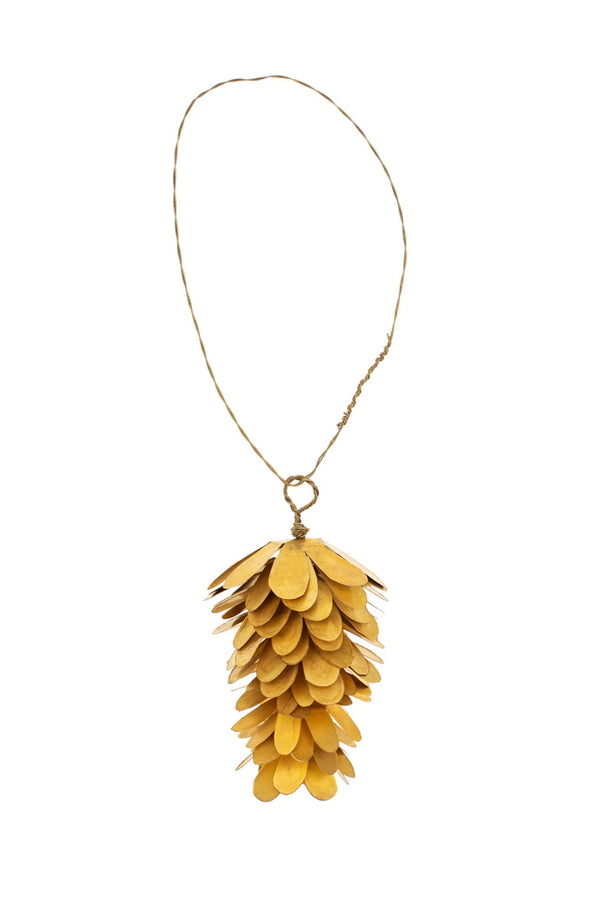 Gold pine cone ornament on a white background