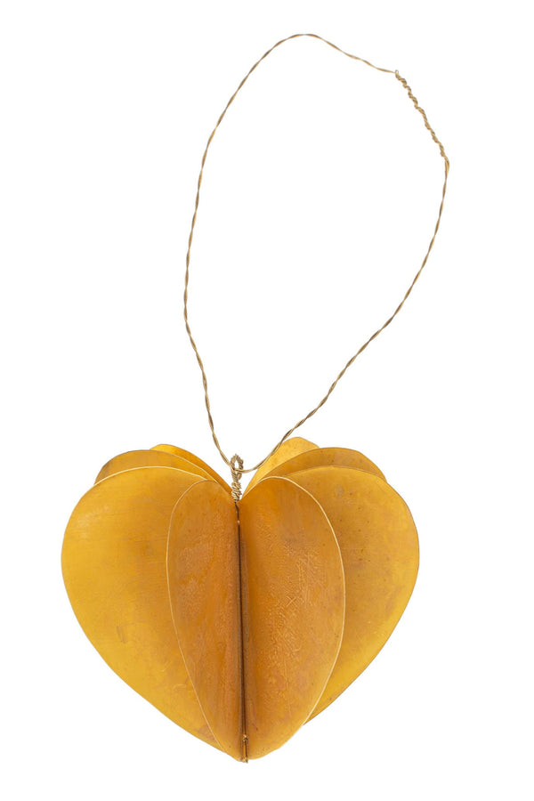 Brass heart-shaped hanging ornament on a white background