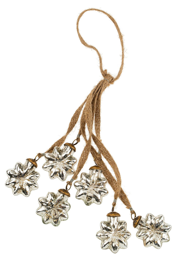 Decorative hanging with silver floral designs and a brown string on a white background