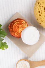 Shower spritzers and a yellow sponge on a white background with a plant.