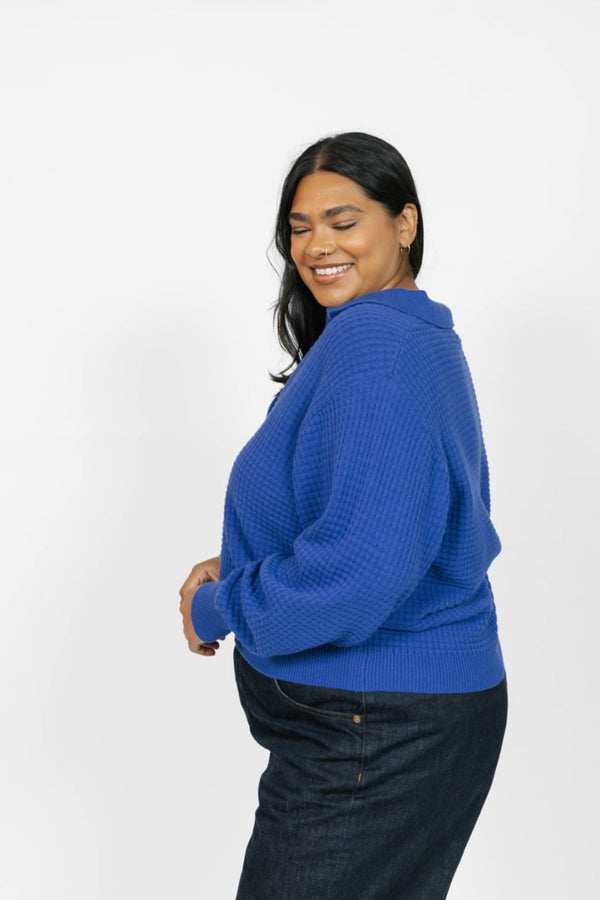 Woman wearing a blue sweater on a white background