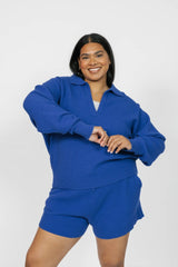 Woman wearing a blue outfit on a white background