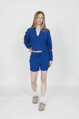 Woman wearing a blue outfit with a white background
