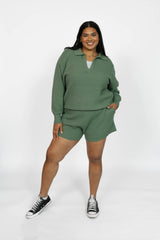 Woman wearing a green outfit with a white background