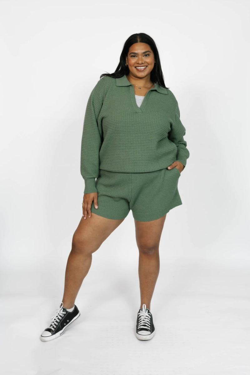 Woman wearing a green outfit with a white background