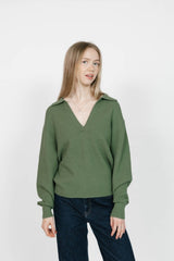 Woman wearing a green checkered shirt against a white background
