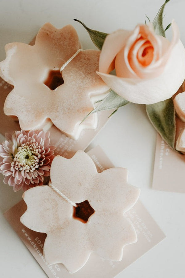 Decorative soap bars with floral designs on a white background