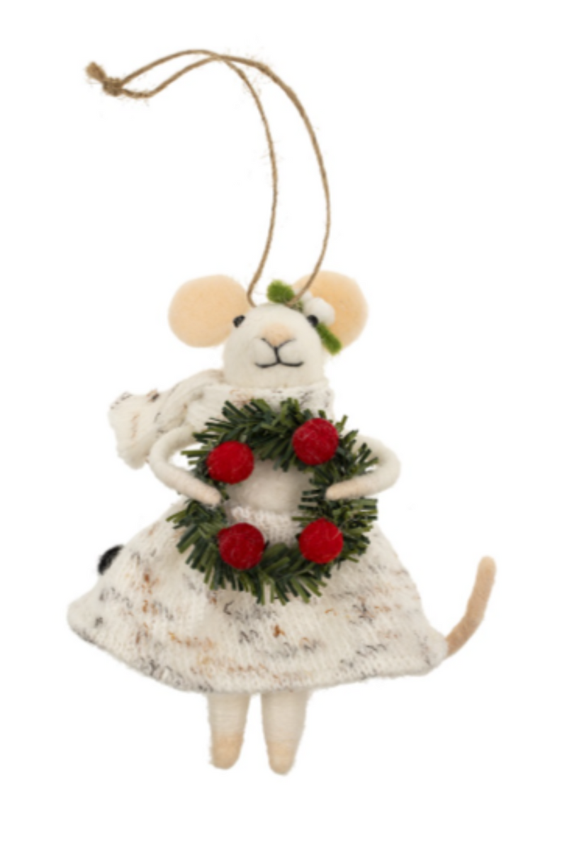 Felt mouse ornament hanging from a string wearing a white dress holding a wreath with red berries on a white background