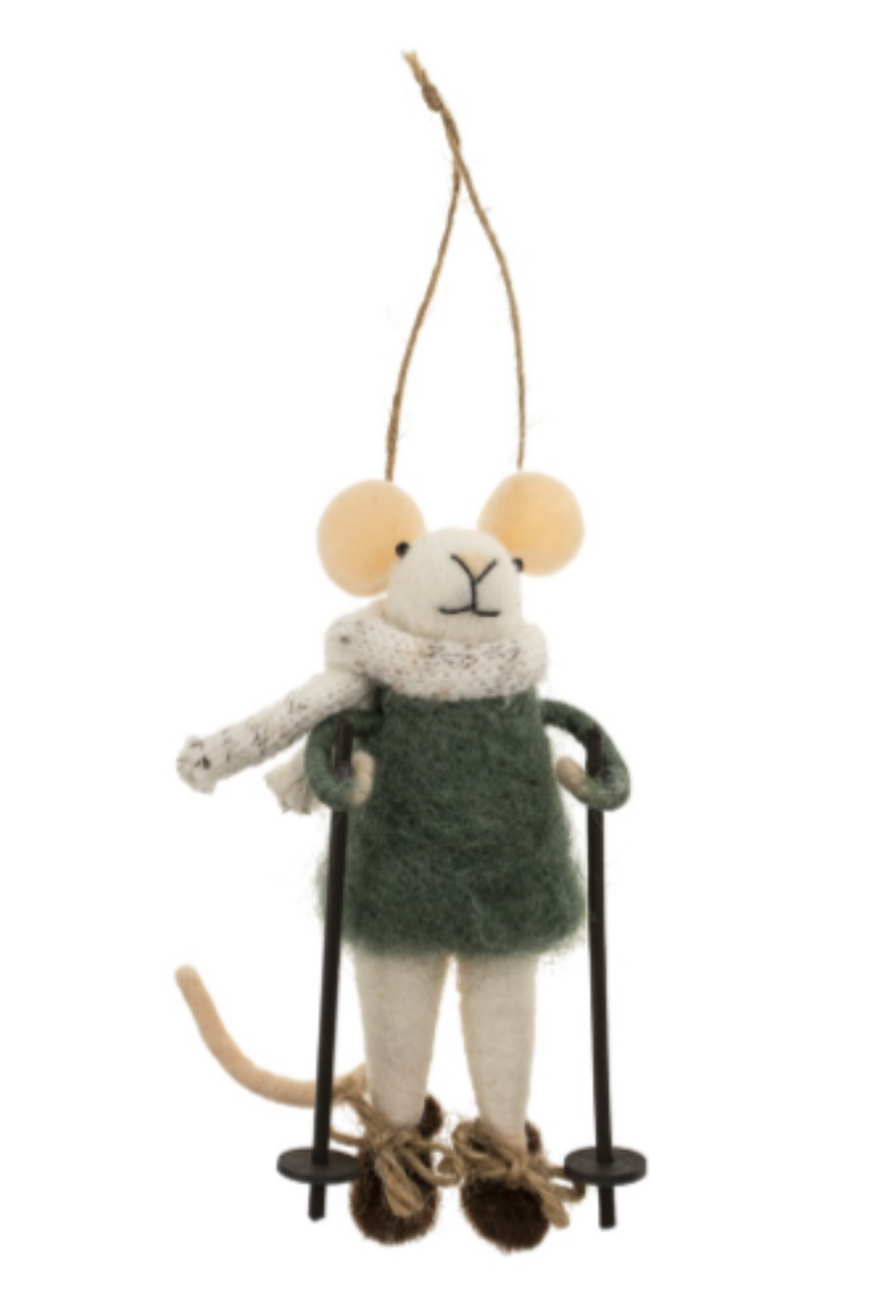 Felt mouse ornament hanging from a string wearing a green sweater and white scarf on skis  against a white background.
