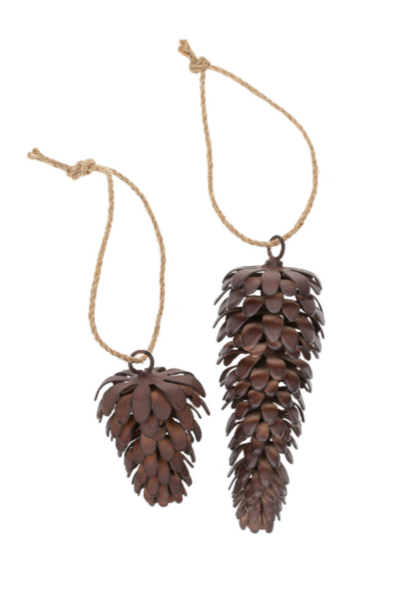 Two pine cone-shaped ornaments hanging from strings on a white background