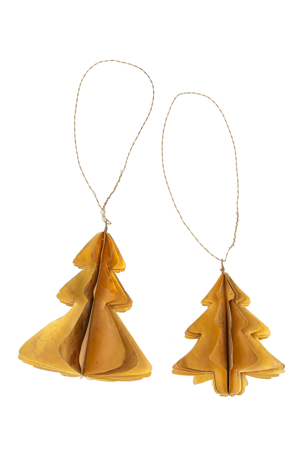 Two brass tree-shaped ornaments hanging on strings against a white background