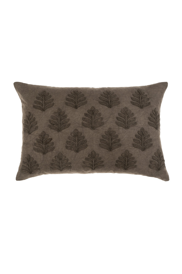 Dark grey pillow with leaf pattern on a white background