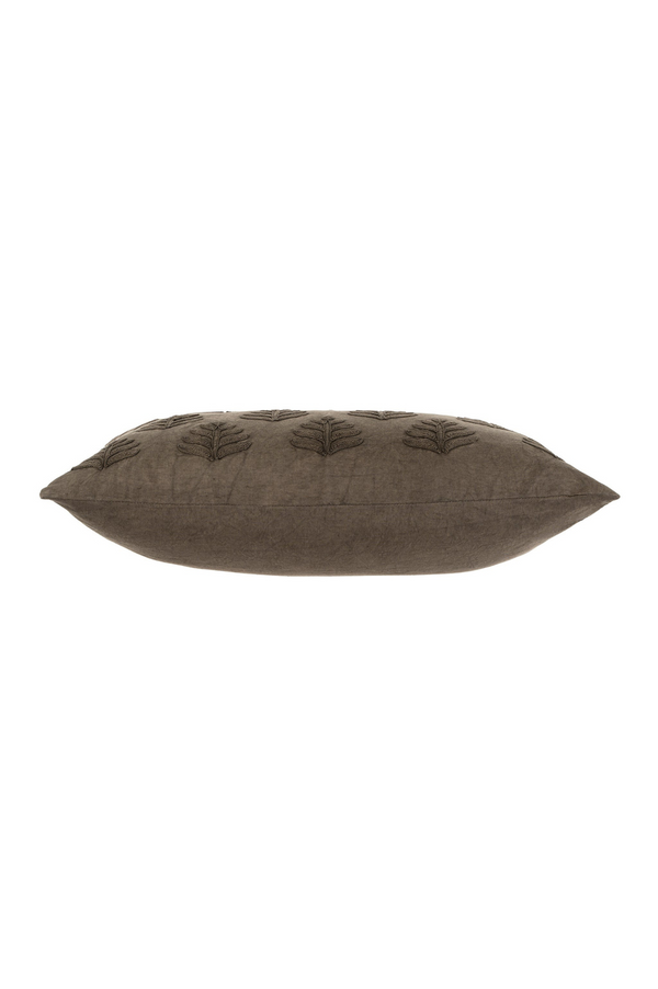Dark grey pillow with leaf pattern on a white background
