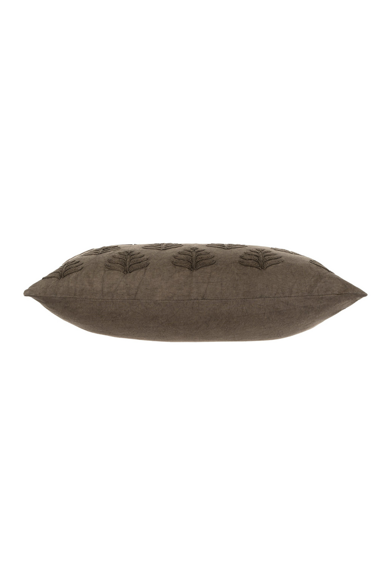 Dark grey pillow with leaf pattern on a white background