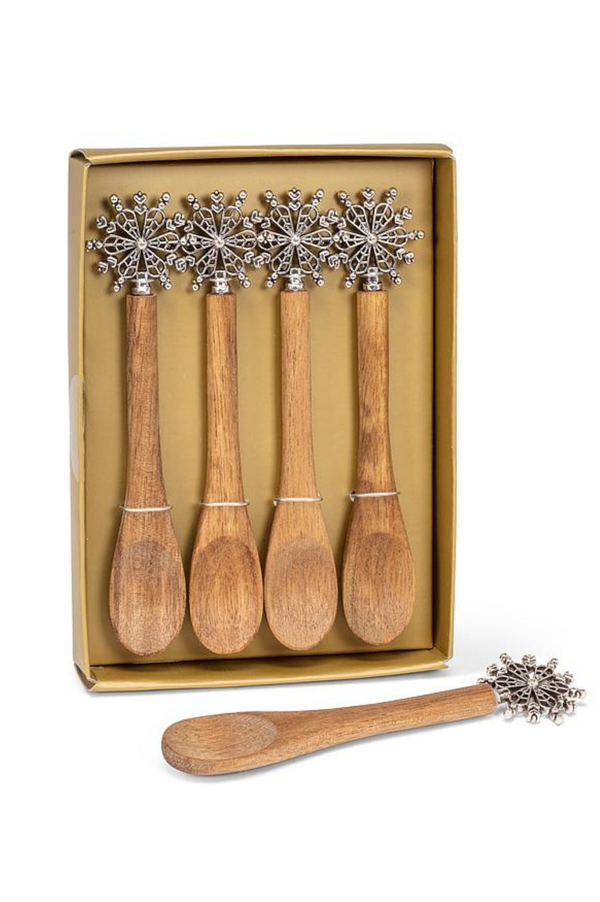 Set of wooden spoons with decorative ends in a gold box on a white background