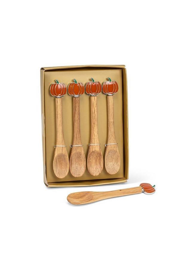 Set of wooden spoons with pumpkin designs in a box on a white background