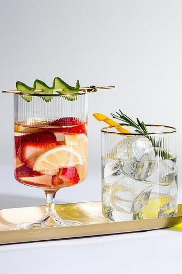 Two cocktails on a tray with a white background