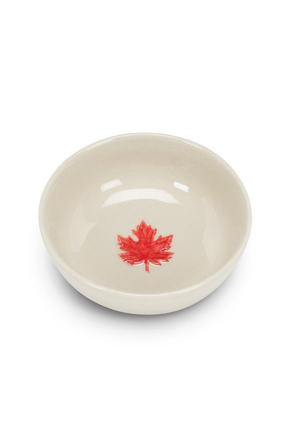 White bowl with a red maple leaf design on a white background
