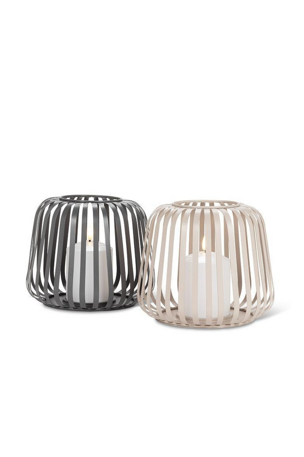 Two candle holders, one grey and one beige, on a white background