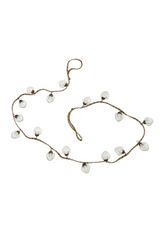 Garland of clear glass ornaments on a white background.