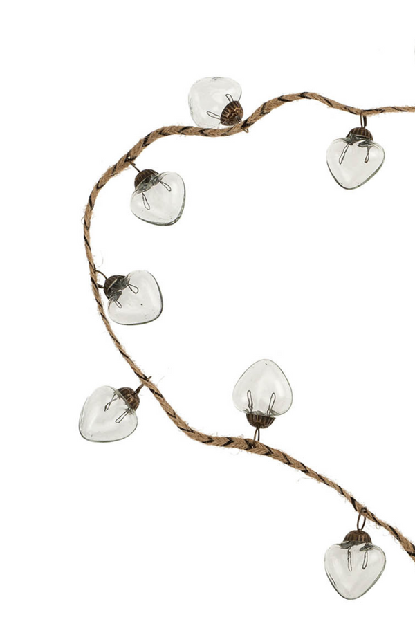 Garland of clear glass ornaments on a white background.