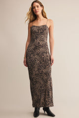 Woman wearing a leopard print dress against a beige background