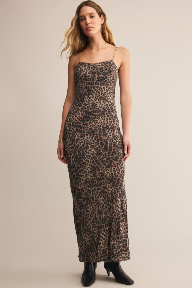 Woman wearing a leopard print dress against a beige background