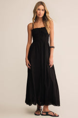Woman wearing a black dress against a beige background
