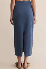 Blue skirt worn by a person on a beige background