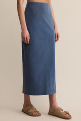 Person wearing a blue skirt on a beige background
