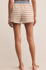 Person wearing striped shorts on a plain background
