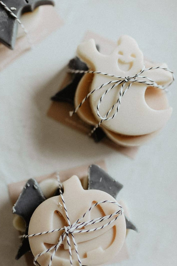 Three Halloween-themed soaps shaped like a bat, ghost, and pumpkin on a white background.