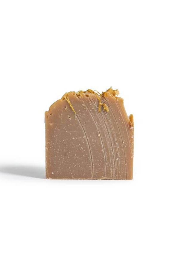 Bar of brown soap on a white background