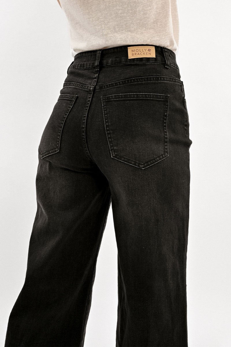 Black jeans with a visible brand label on a white background