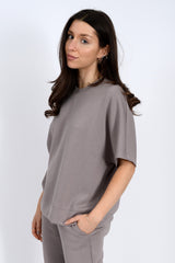 Woman wearing a gray outfit on a white background