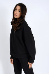 Woman wearing a black outfit on a white background