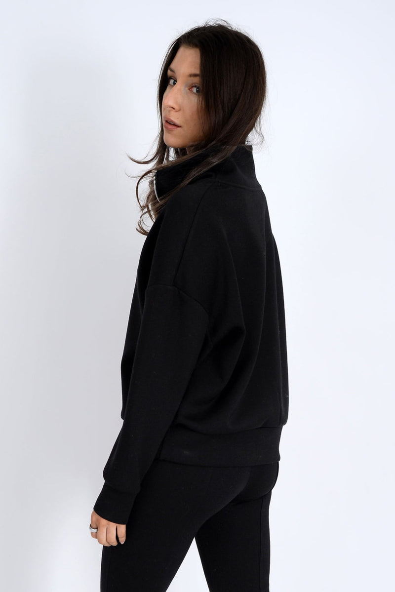 Person wearing a black outfit on a white background