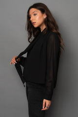 Woman wearing a black outfit against a gray background